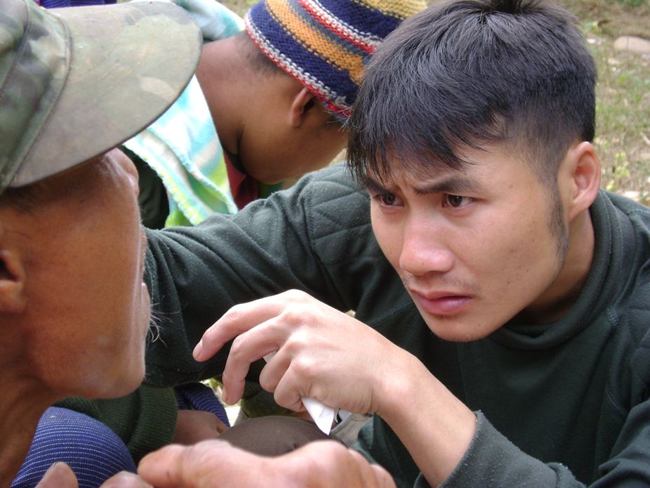 Medic providing medical attention to an IDP villager