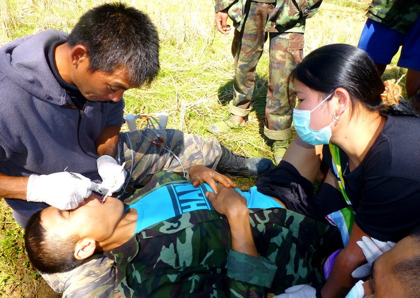 FBR medic works on a patient's tooth in the field