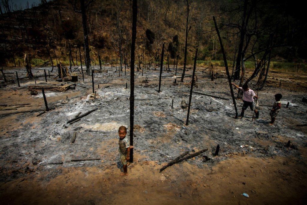 Refugees and their burned homes (1)