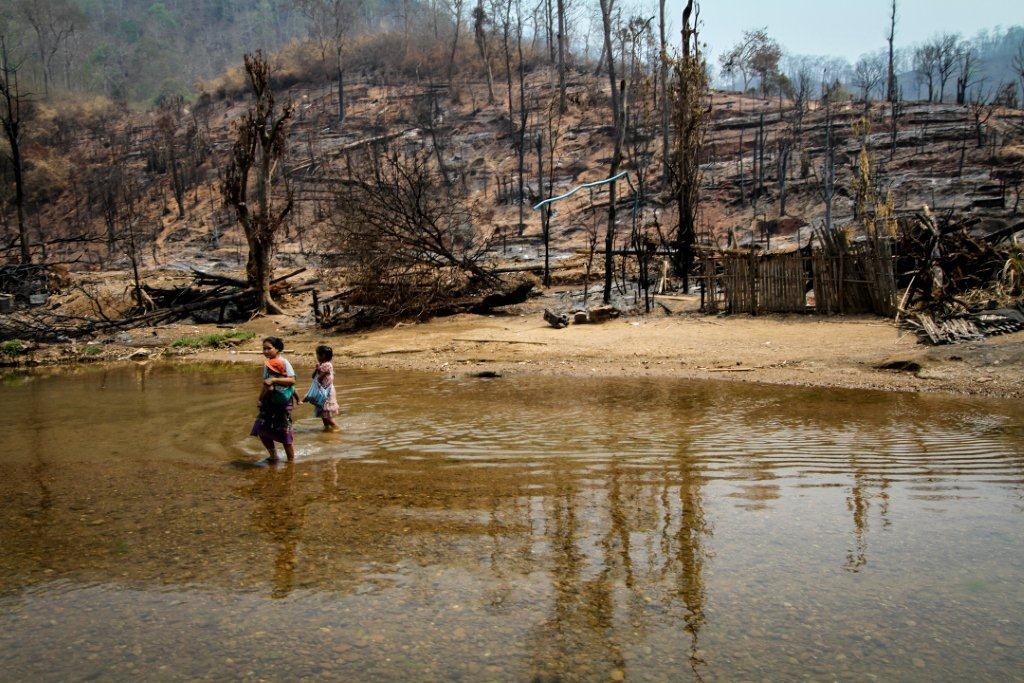 Refugees and their burned homes (2)