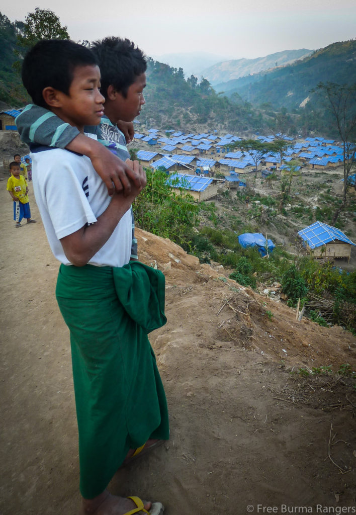 Young Kachin boys look over an IDP camp