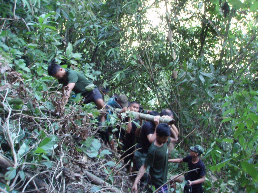 Rangers on side of ravine carrying Stephanie
