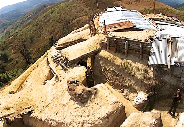 Opium Militia Army Camp on hill above opium fields Burma flag wrapped on pole Pansay Area Shan State, Burma