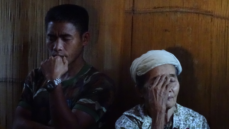 Pu Maw La's wife and son at his memorial.