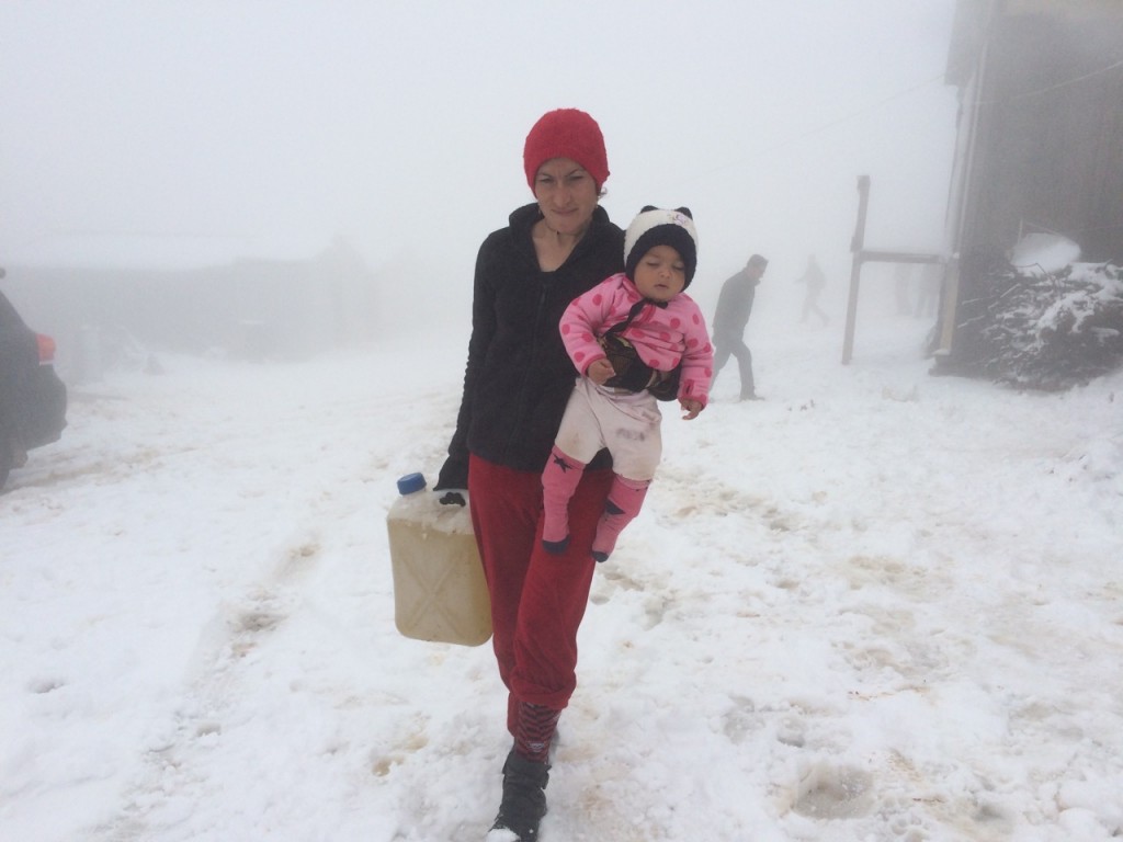 Displaced Yizidi mother in the snow on Sinjar Mountain