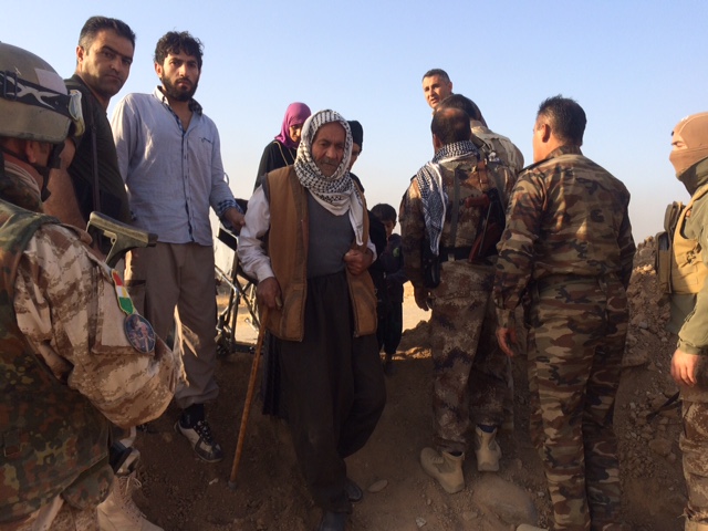 An old man walks through Peshmerga screening. Photo: FBR.