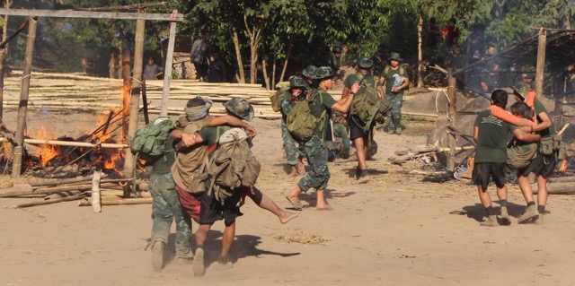 Relief teams train to evacuate injured villagers under attack