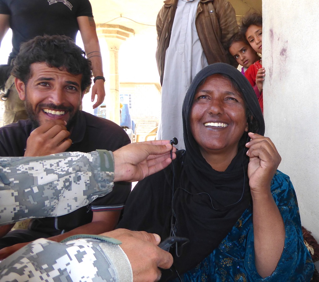 Woman with a stroke and her husband listen to the Bible in Arabic on a MP3 player
