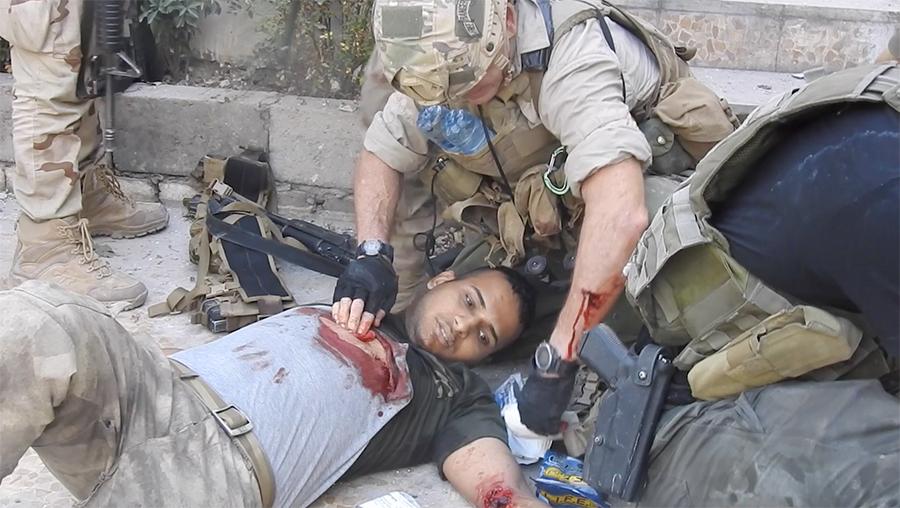Lt. Hussein, shot five times, being treated by Dave.