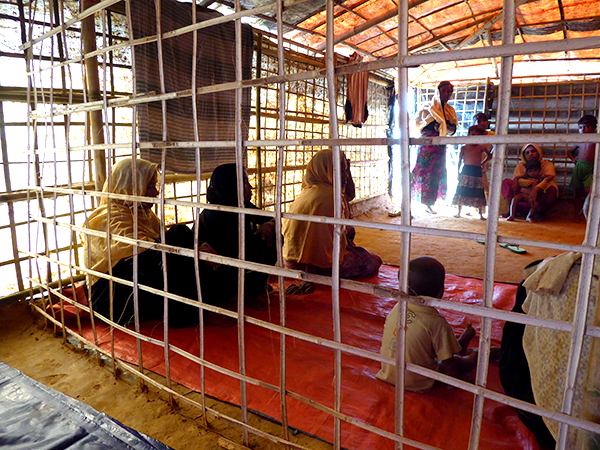 An open wall divides the men and women during the interviews in Kutapalong Camp.